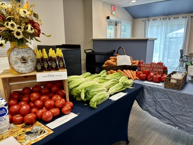 A market set out on tables in a community room